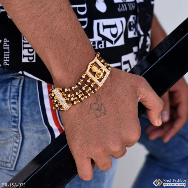 Gold bracelet with diamond clasp featuring Goga Maharaj logo