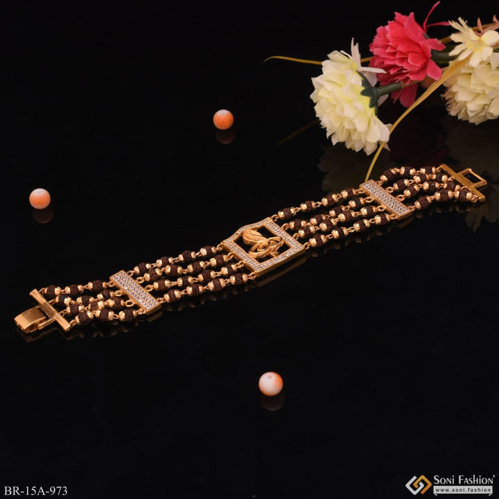 Gold bracelet with cross and flower from 4 Line Rudraksha Bracelet with Diamond & Goga Maharaj Logo - Style A973.