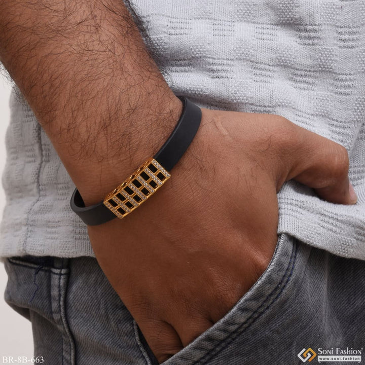 Stylish man wearing diamond gold plated rubber bracelet.