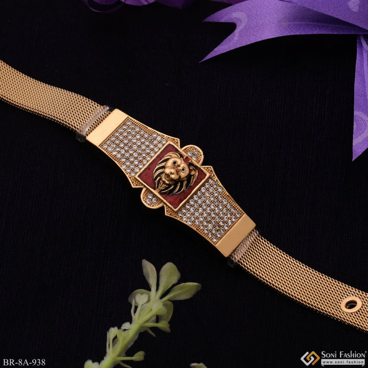 Gold plated stainless steel lion bracelet with red background.