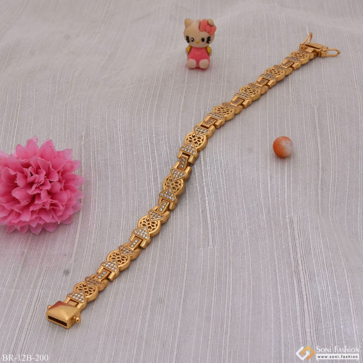 Gold bracelet with bell next to flower, Diamond decorative design, Flower with diamond, Style B200