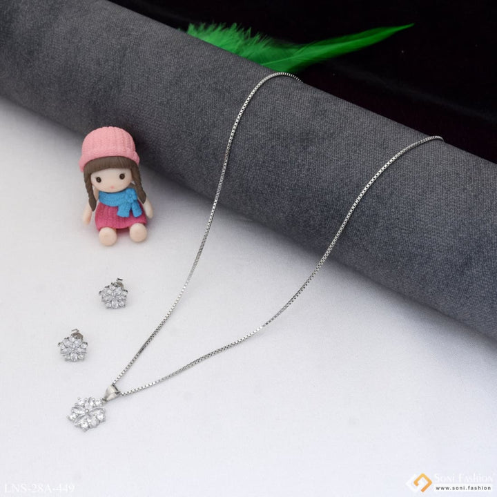 Silver necklace set with doll wearing pink hat and necklace