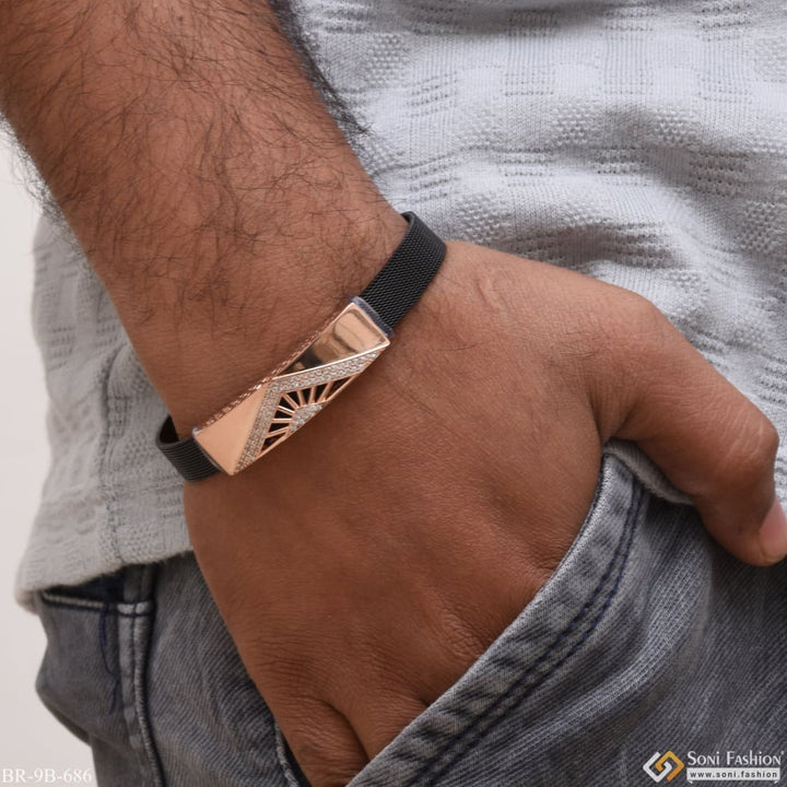 Rose gold bracelet with a man wearing black and gold bracelet