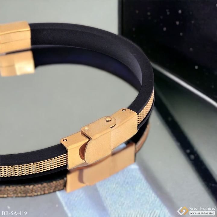 Trending fancy black and gold rubber bracelet displayed on table