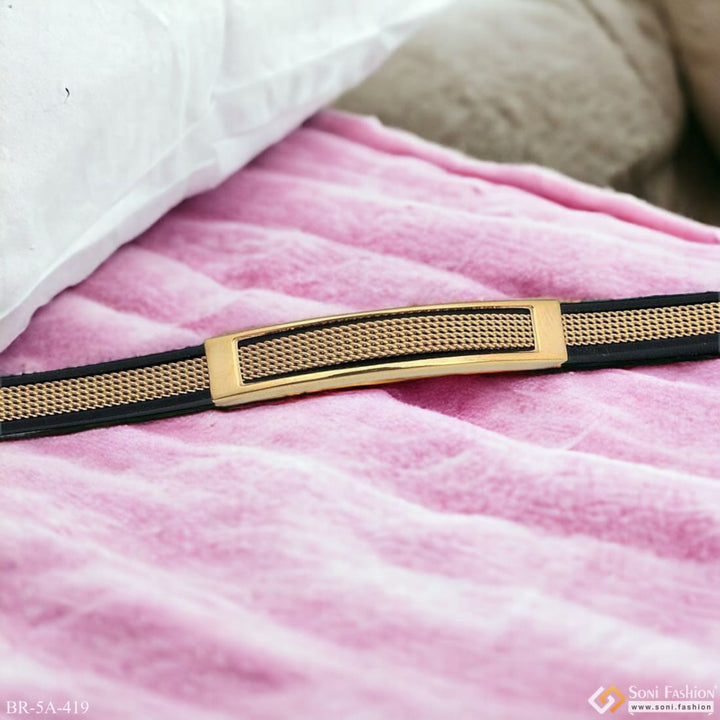 Golden buckle on pink blanket displayed on Very Trending Fancy Black Rubber Bracelet - Style A419